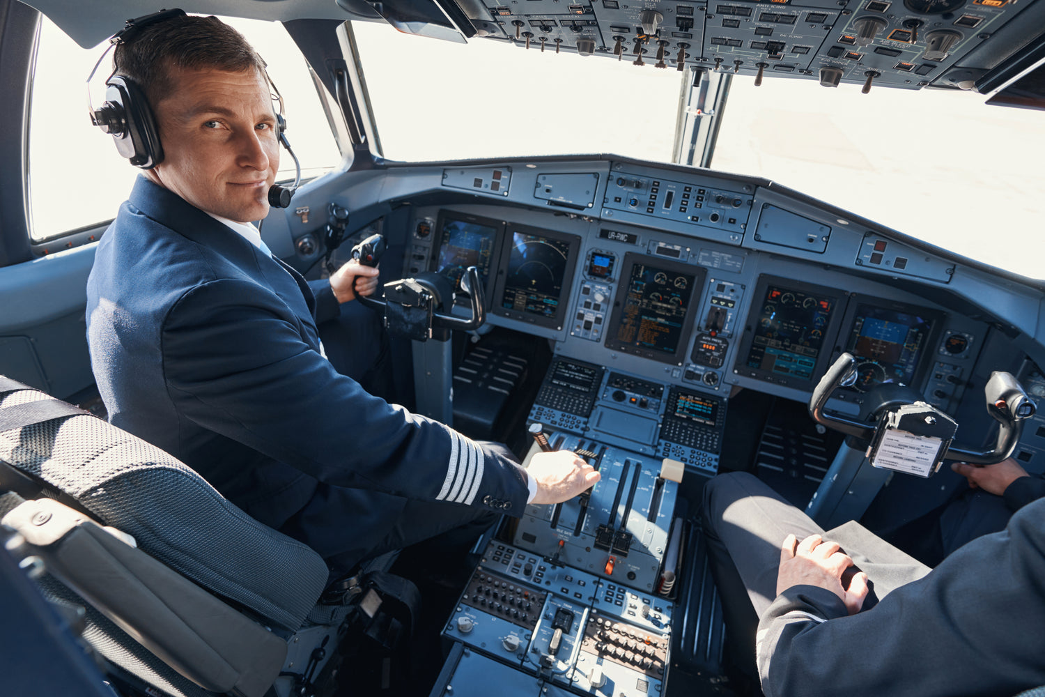 Clean Shaved Pilot in Cockpit with controls visible