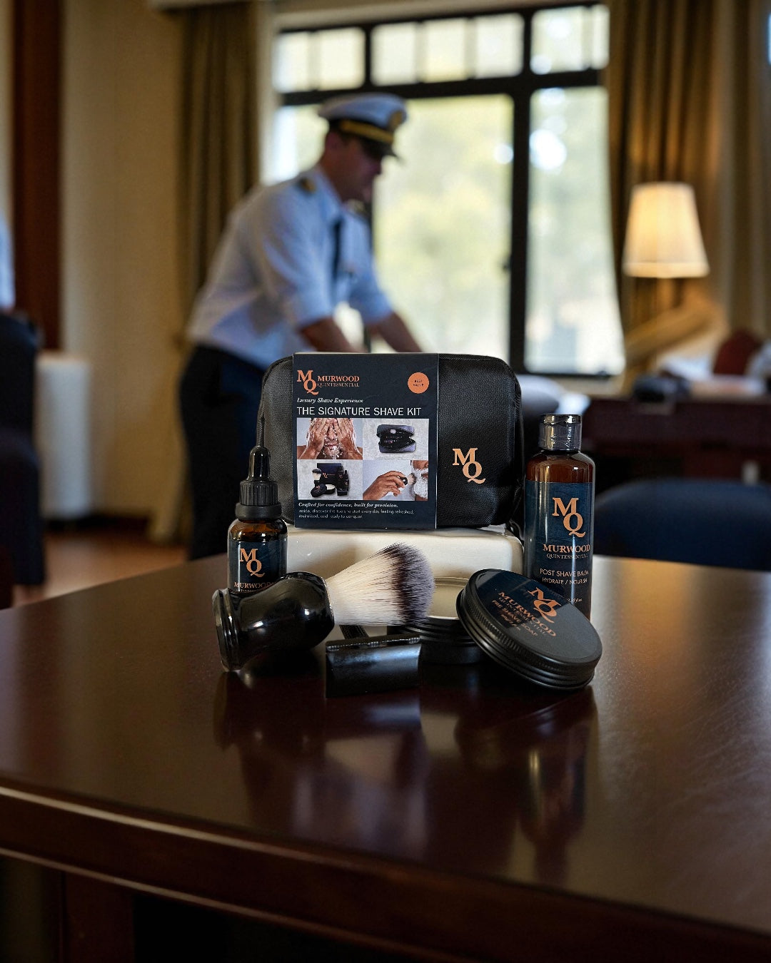 Murwood Quintessential Grooming products on a table with a blurred background of a room.