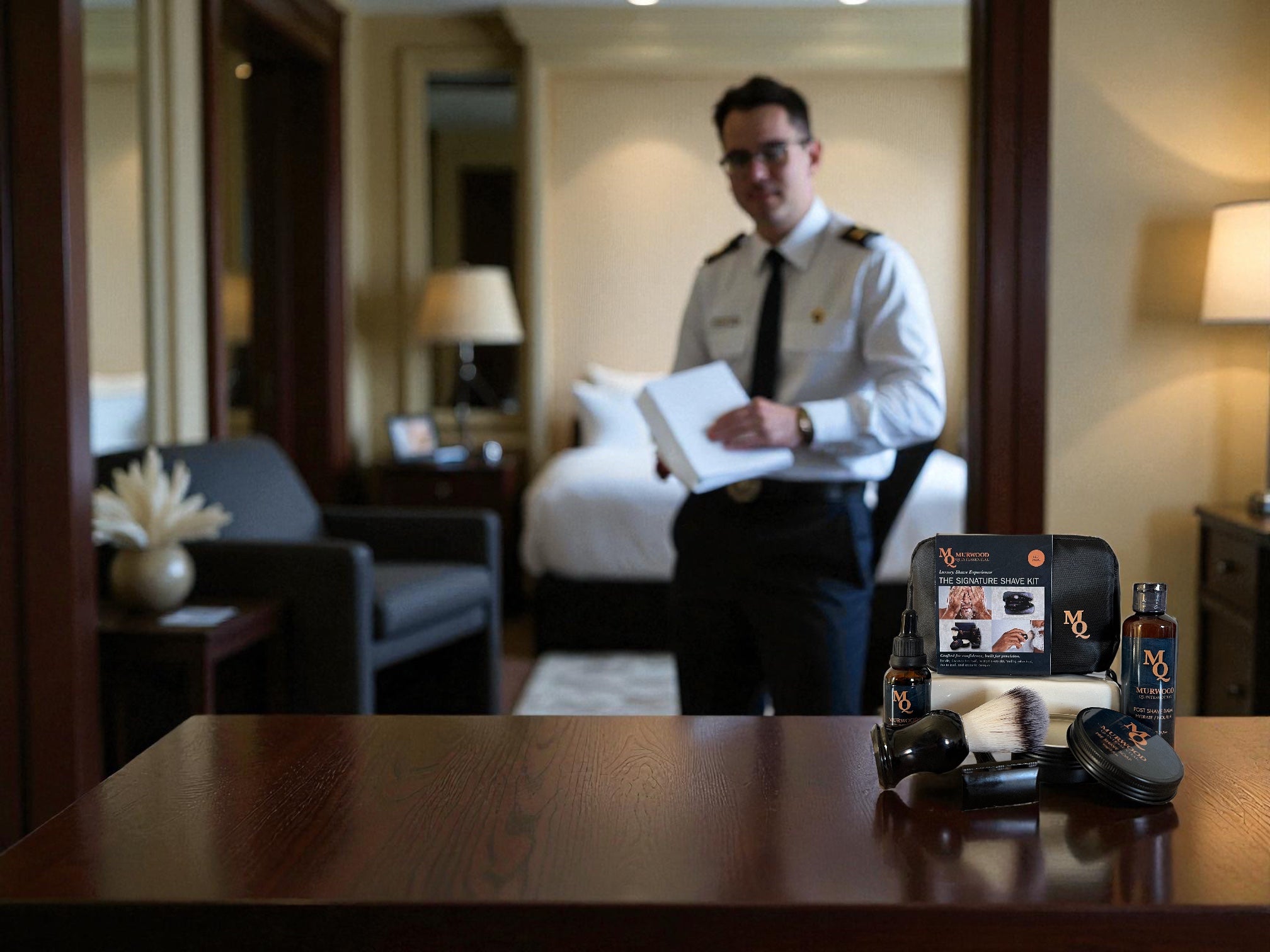 Pilot in a hotel room with male grooming kit on desk and bed in the background